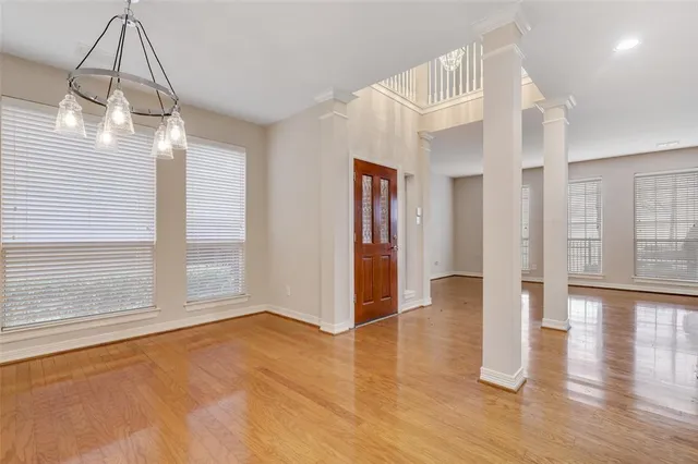 a view of a room with wooden floor and windows