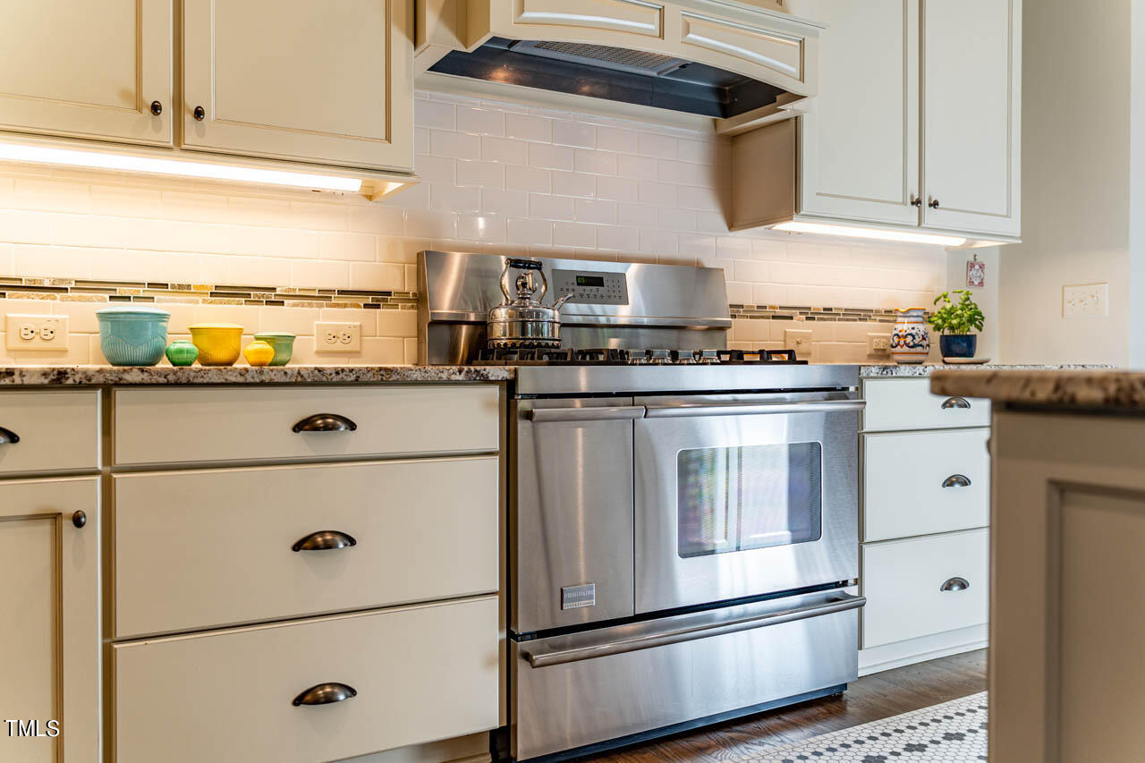 499 Bennett Mountain Trace Chapel Hill, NC 27516 - Photo 14 of 75 a kitchen with stainless steel appliances granite countertop a sink and a refrigerator