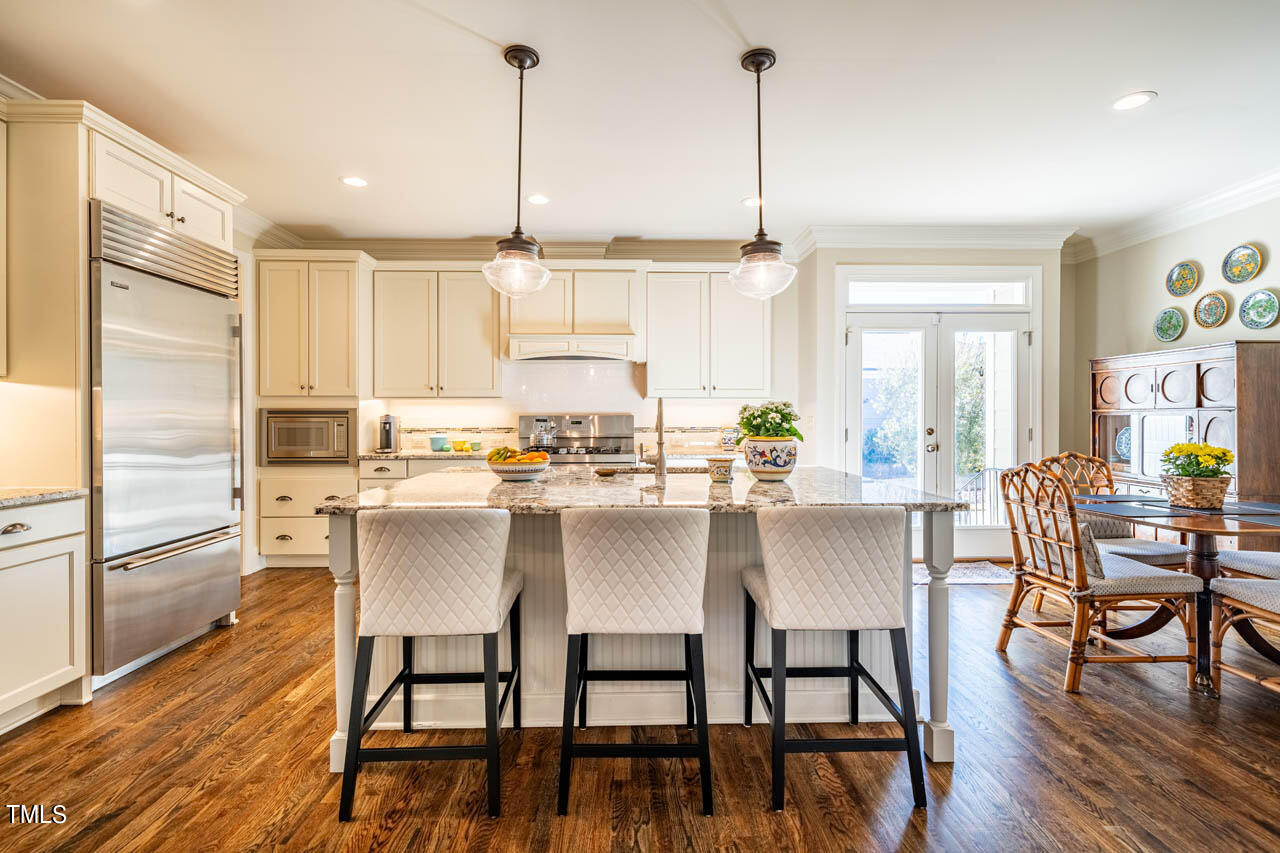 499 Bennett Mountain Trace Chapel Hill, NC 27516 - Photo 15 of 75 a view of kitchen with dining table chairs wooden floor and appliances