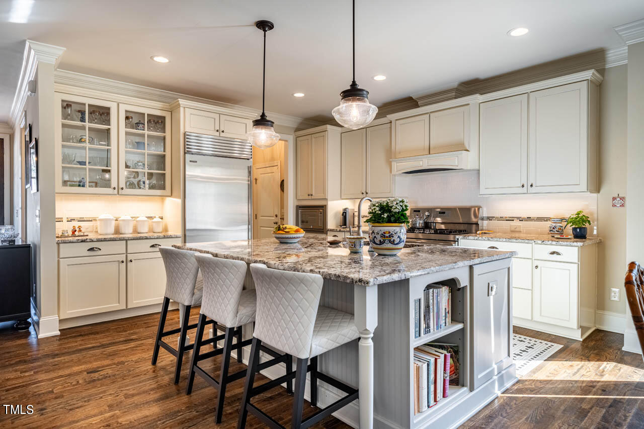 499 Bennett Mountain Trace Chapel Hill, NC 27516 - Photo 17 of 75 a kitchen with kitchen island granite countertop a sink a center island and cabinets