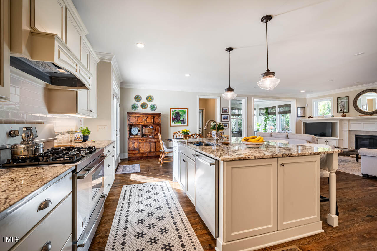 499 Bennett Mountain Trace Chapel Hill, NC 27516 - Photo 19 of 75 a kitchen with kitchen island granite countertop lots of counter top space and stainless steel appliances