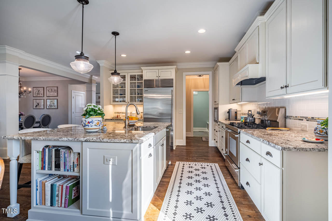 499 Bennett Mountain Trace Chapel Hill, NC 27516 - Photo 20 of 75 a kitchen with stainless steel appliances granite countertop a stove a sink and cabinets