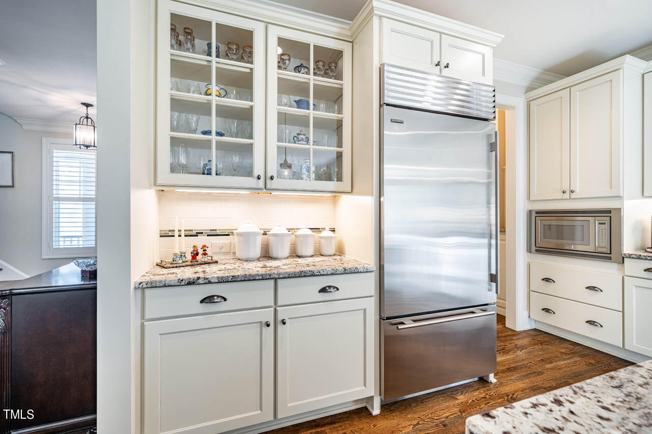 499 Bennett Mountain Trace Chapel Hill, NC 27516 - Photo 22 of 75 a kitchen with stainless steel appliances granite countertop a refrigerator and a stove top oven