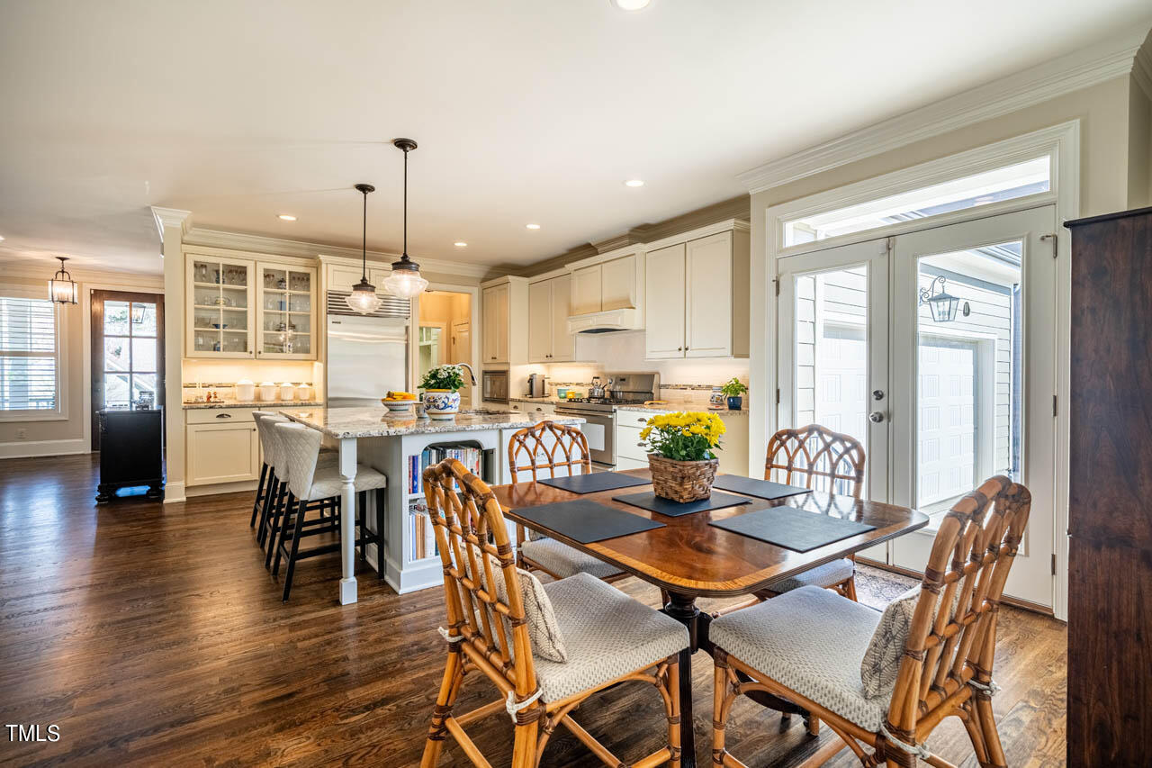 499 Bennett Mountain Trace Chapel Hill, NC 27516 - Photo 28 of 75 a dining room with stainless steel appliances kitchen island granite countertop a dining table chairs and a refrigerator