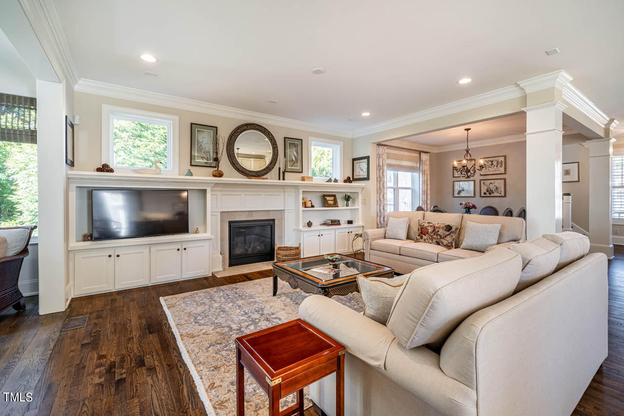 499 Bennett Mountain Trace Chapel Hill, NC 27516 - Photo 29 of 75 a living room with furniture a flat screen tv and a fireplace