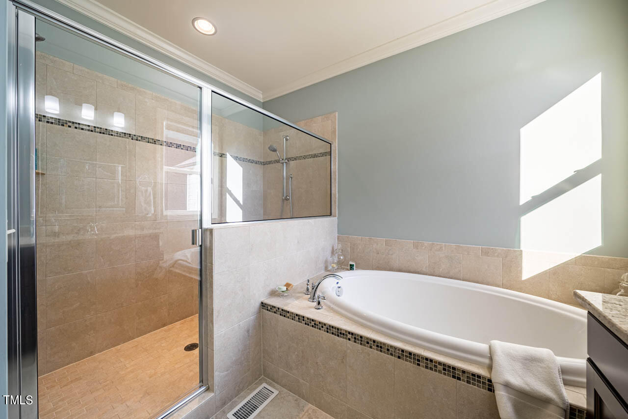 499 Bennett Mountain Trace Chapel Hill, NC 27516 - Photo 43 of 75 a bathroom with a granite countertop bathtub and shower