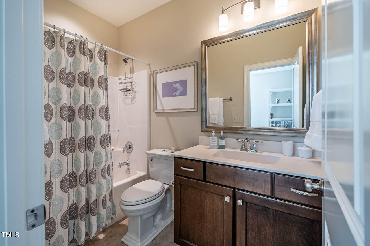 499 Bennett Mountain Trace Chapel Hill, NC 27516 - Photo 54 of 75 a bathroom with a sink a toilet a mirror and shower curtain