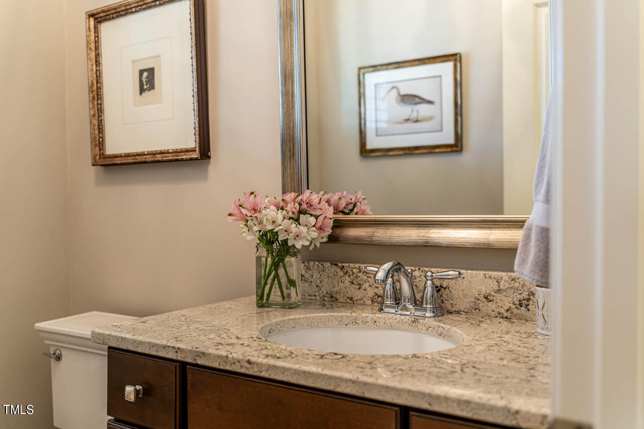 499 Bennett Mountain Trace Chapel Hill, NC 27516 - Photo 9 of 75 a bathroom with a granite countertop sink and a mirror