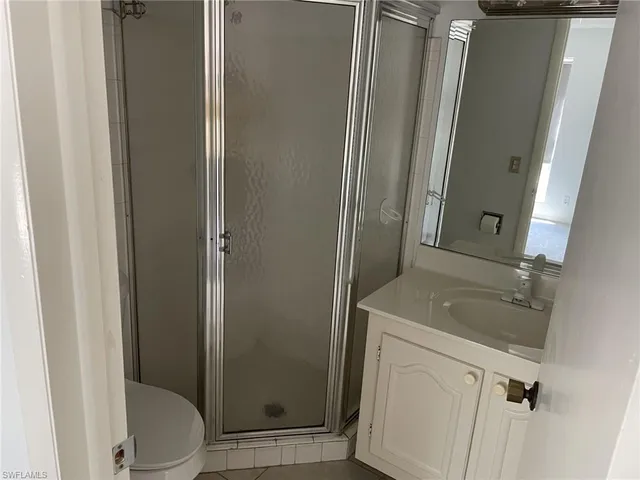 a bathroom with a sink and mirror with toilet