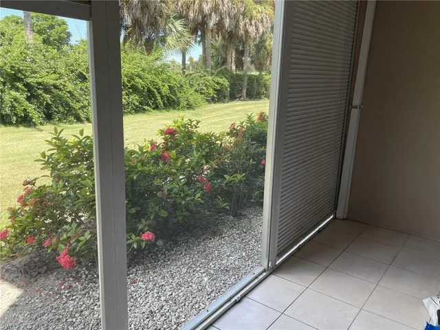 a view of a room with a tree in the background