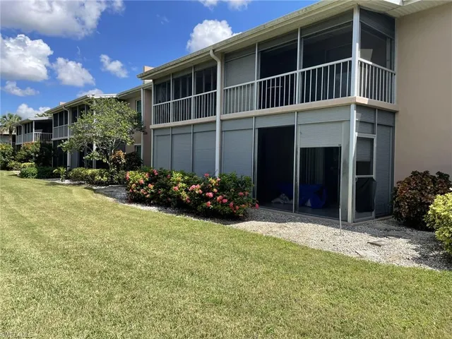 a view of a house with yard and sitting area