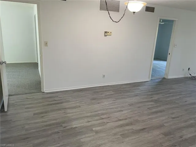 a view of a room with wooden floor and glass door