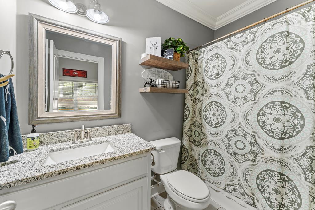 2800 Hopewell Church Road Pine Mountain, GA 31822 - Photo 26 of 39 a bathroom with a granite countertop toilet a sink and a mirror