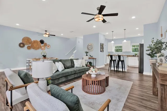a living room with furniture and wooden floor