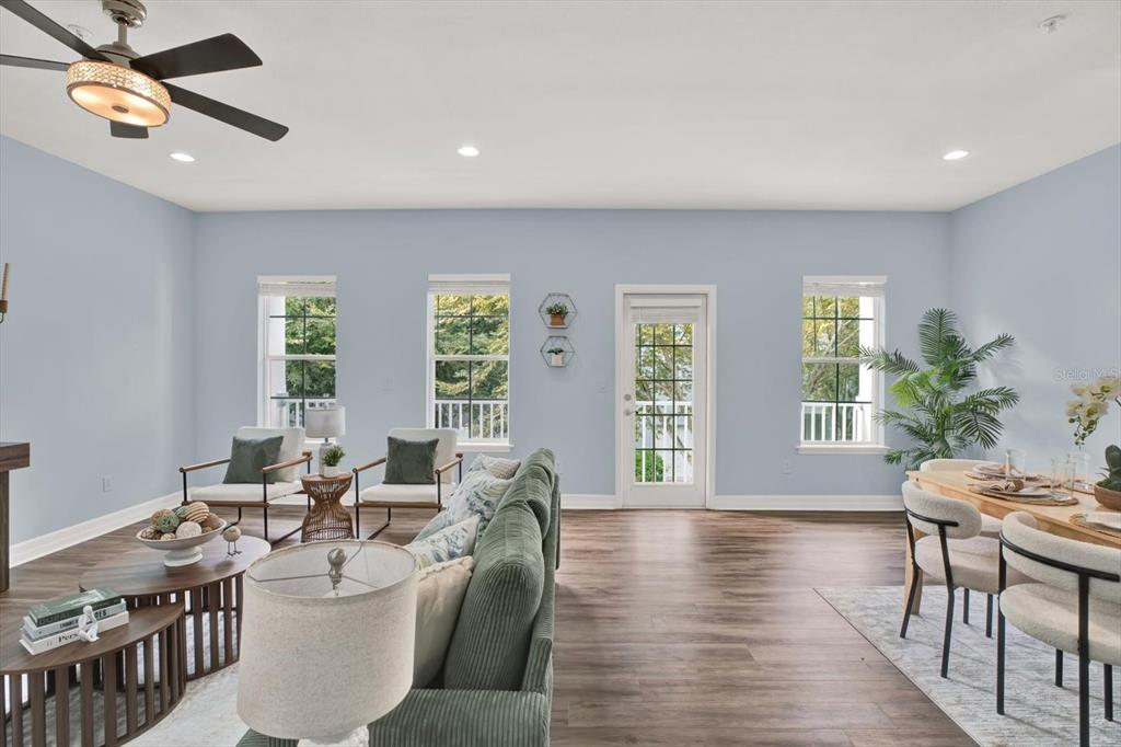 4529 Bay Spring Court Tampa, FL 33611 - Photo 14 of 66 a living room with furniture two window and wooden floor