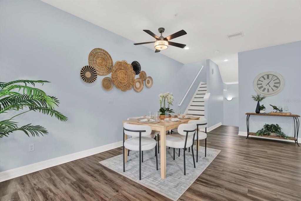 4529 Bay Spring Court Tampa, FL 33611 - Photo 17 of 66 a view of a dining room with furniture and wooden floor