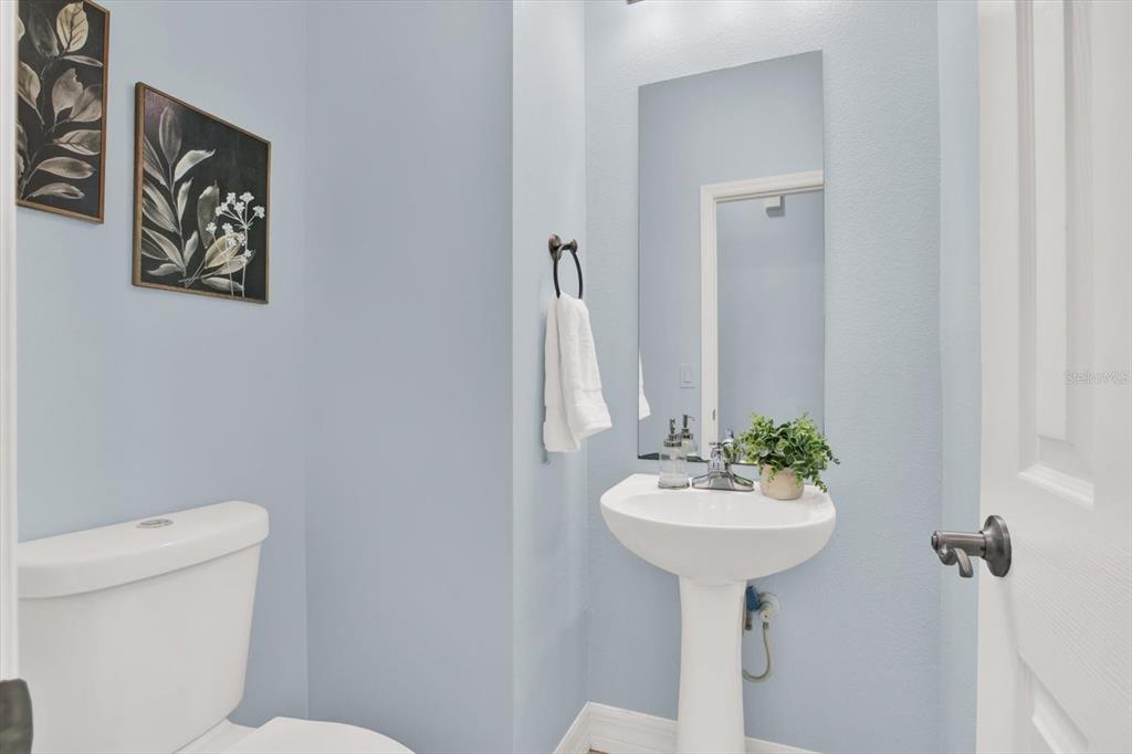 4529 Bay Spring Court Tampa, FL 33611 - Photo 22 of 66 a bathroom with a sink a mirror and a toilet