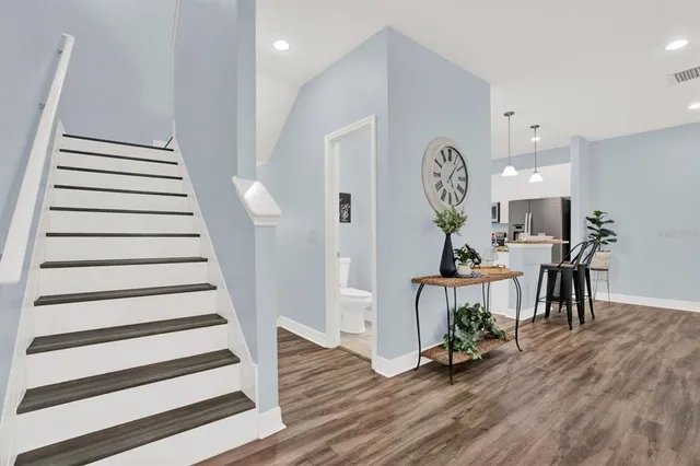 a view of an empty room with wooden floor
