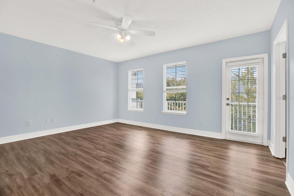 4529 Bay Spring Court Tampa, FL 33611 - Photo 24 of 66 an empty room with wooden floor and windows