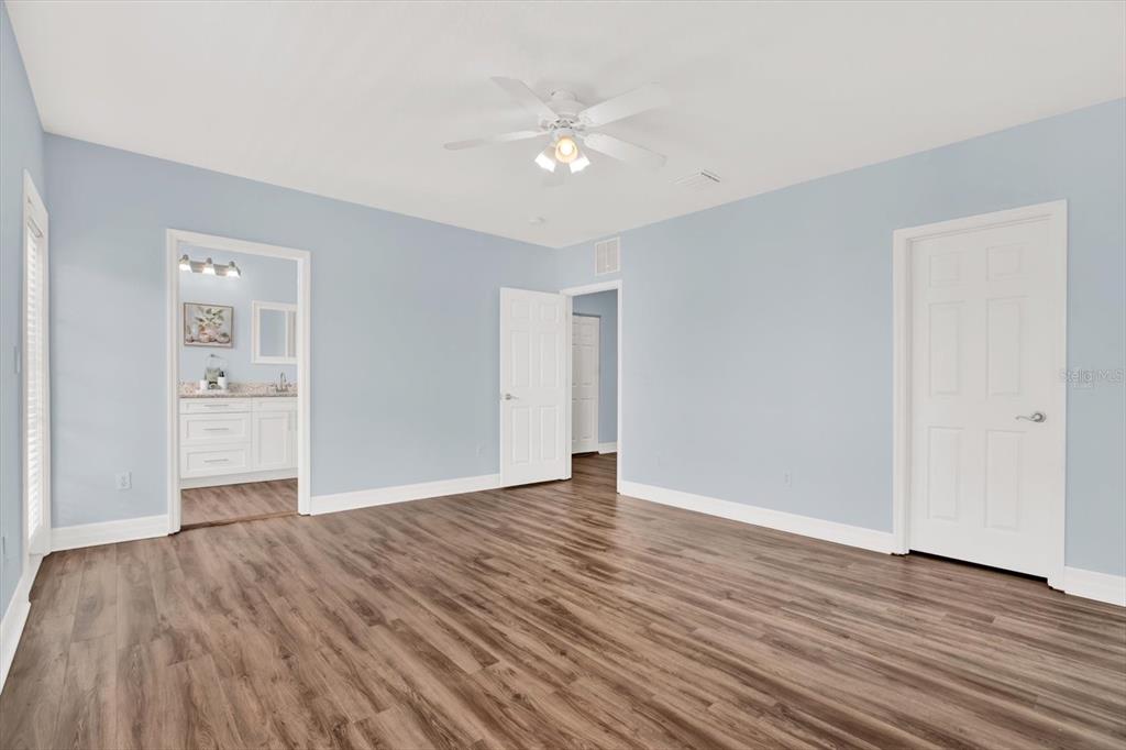 4529 Bay Spring Court Tampa, FL 33611 - Photo 26 of 66 a view of an empty room with wooden floor