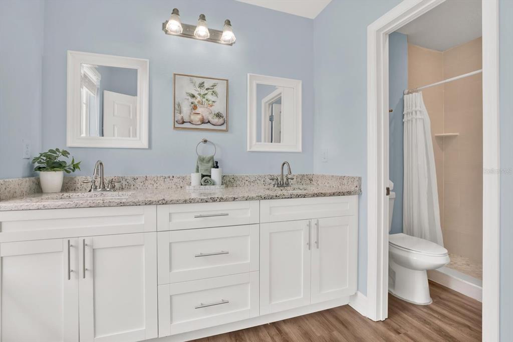 4529 Bay Spring Court Tampa, FL 33611 - Photo 27 of 66 a bathroom with a granite countertop sink mirror and toilet