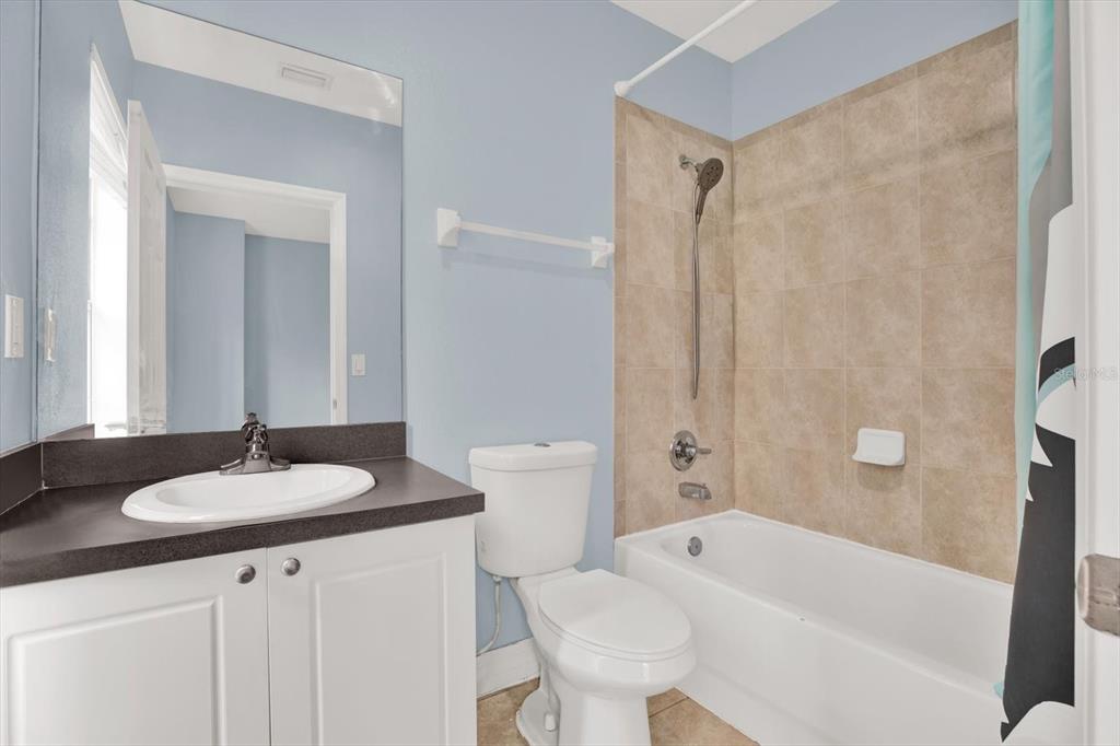 4529 Bay Spring Court Tampa, FL 33611 - Photo 32 of 66 a bathroom with a granite countertop sink and a mirror