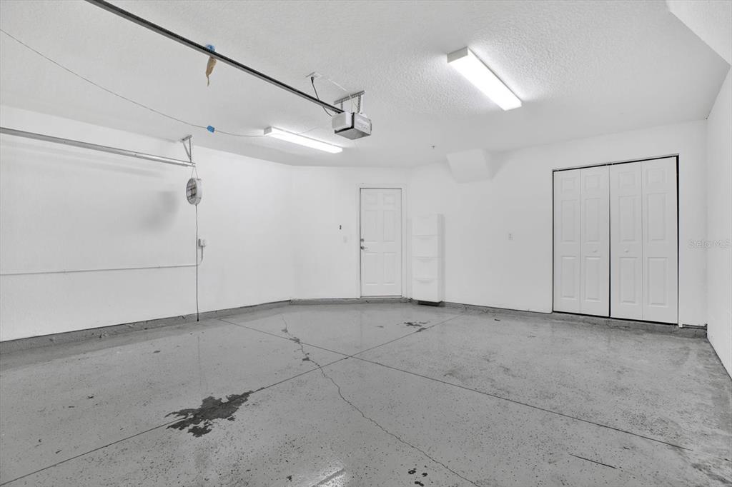 4529 Bay Spring Court Tampa, FL 33611 - Photo 35 of 66 an empty room with projector & cabinets