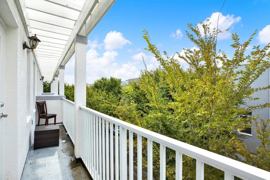 4529 Bay Spring Court Tampa, FL 33611 - Photo 41 of 66 a view of a balcony with wooden floor and fence