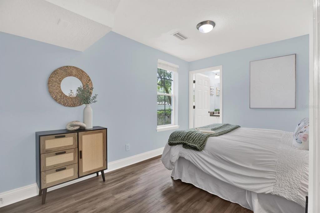 4529 Bay Spring Court Tampa, FL 33611 - Photo 5 of 66 a bedroom with a bed and a chandelier