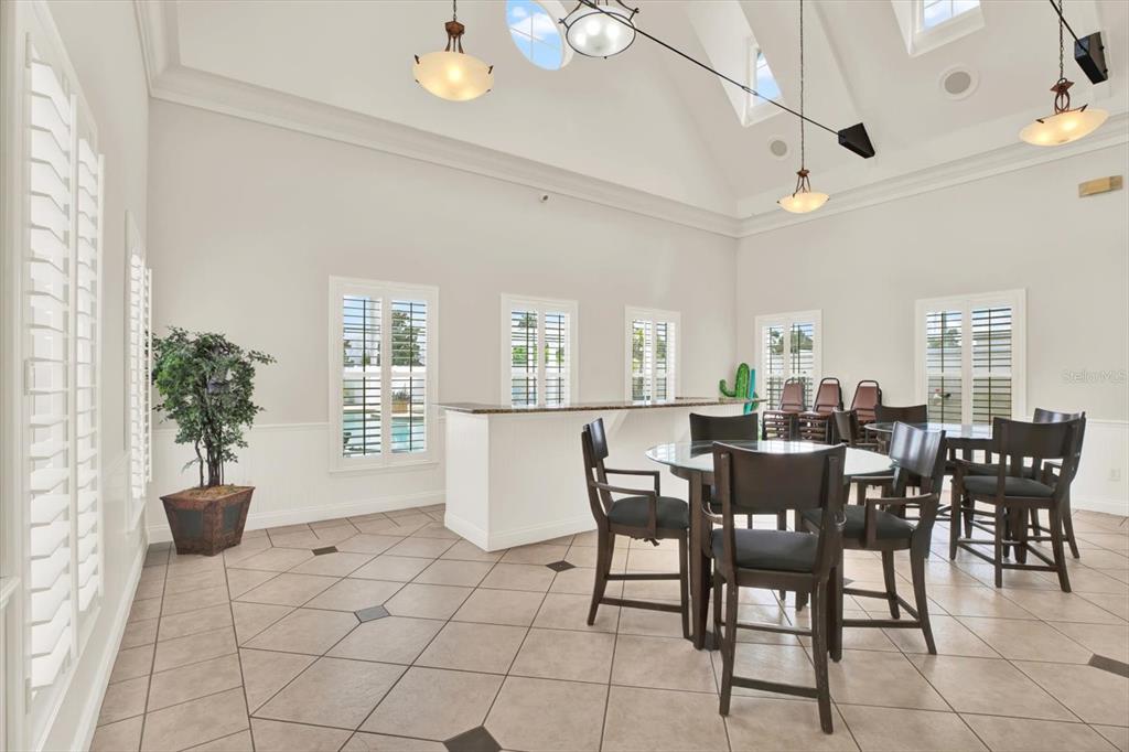 4529 Bay Spring Court Tampa, FL 33611 - Photo 61 of 66 a view of a dining room with furniture and chandelier
