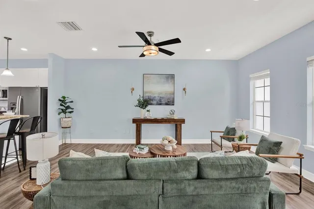 a living room with furniture potted plant and a chandelier