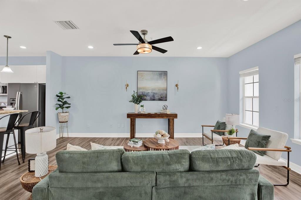 4529 Bay Spring Court Tampa, FL 33611 - Photo 10 of 66 a living room with fireplace furniture and a chandelier