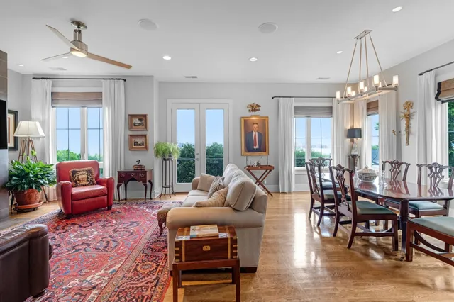 a living room with furniture and a chandelier