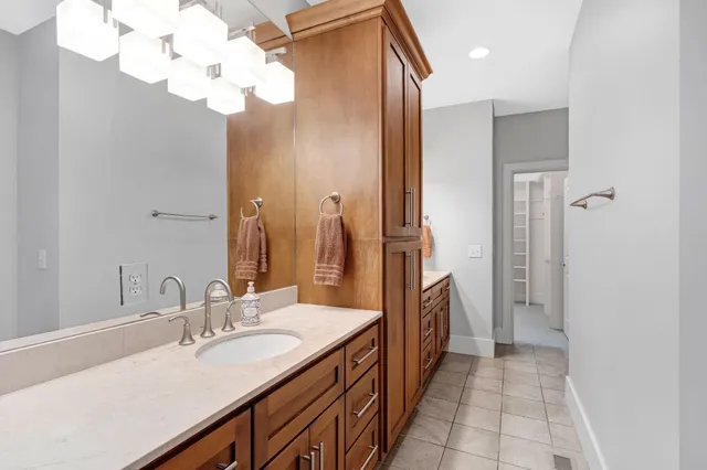 a spacious bathroom with a granite countertop sink a mirror and a shower