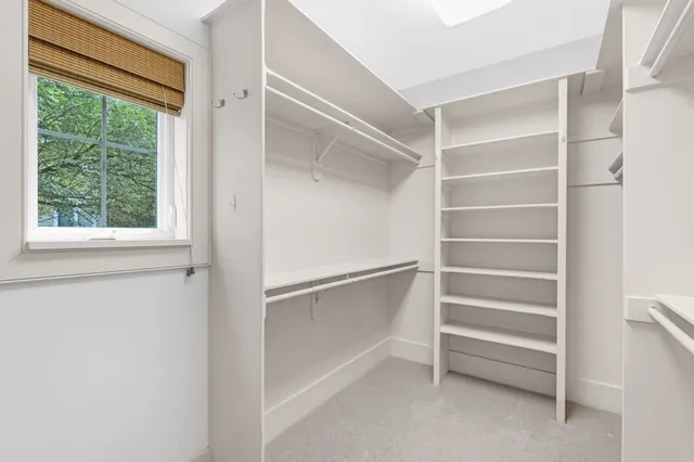 a view of walk in closet with empty racks