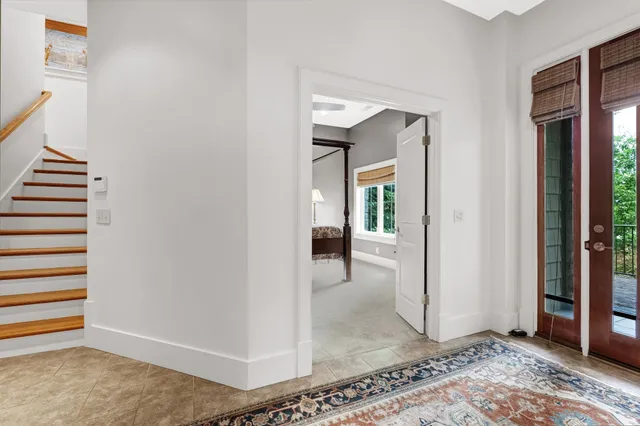 a view of a hallway with entryway and livingroom view