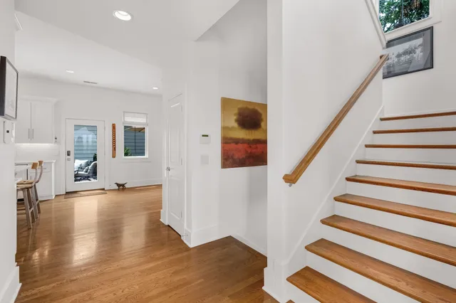 a view of an entryway with wooden floor and a livingroom view