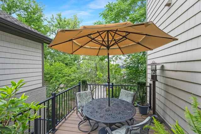 a view of a balcony with furniture and umbrella