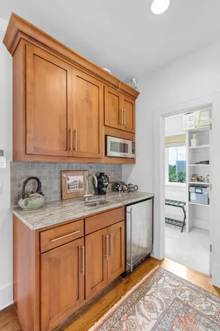 a kitchen with stainless steel appliances granite countertop a stove a sink and a microwave