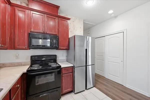 a kitchen with a refrigerator stove and microwave