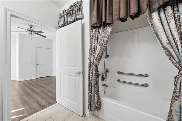 a bathroom with a bathtub and a shower