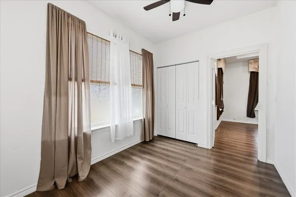 a view of a hallway with wooden floor