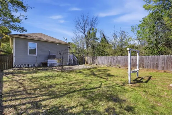 a backyard of a house with table and chairs
