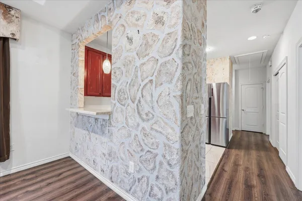 a view of a bathroom with wooden floor and a carpet