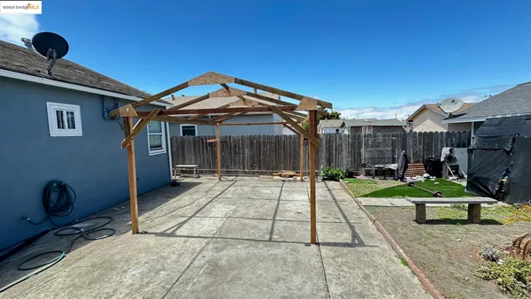 a view of house with backyard space and patio