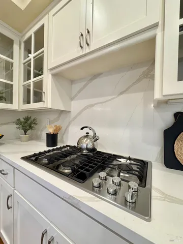 a close view of a stove a microwave and cabinets