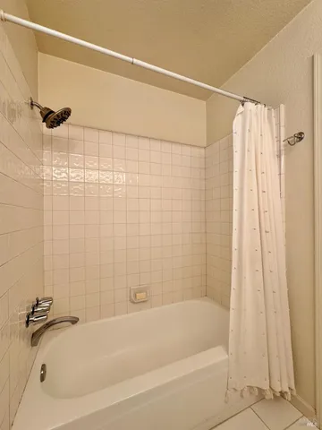 a bathroom with a shower and a bathtub