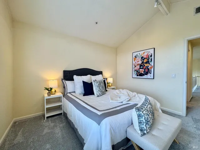 a bedroom with a bed and a couch