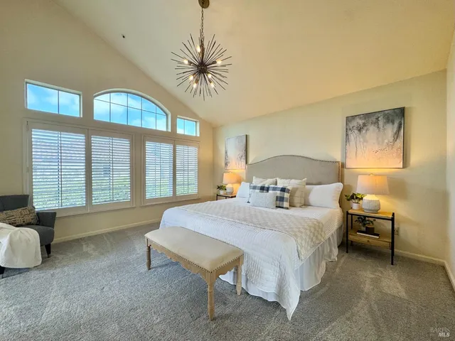 a bedroom with a bed and glass walk in closet