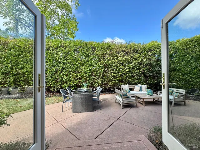 a view of a patio with potted plants and a fountain
